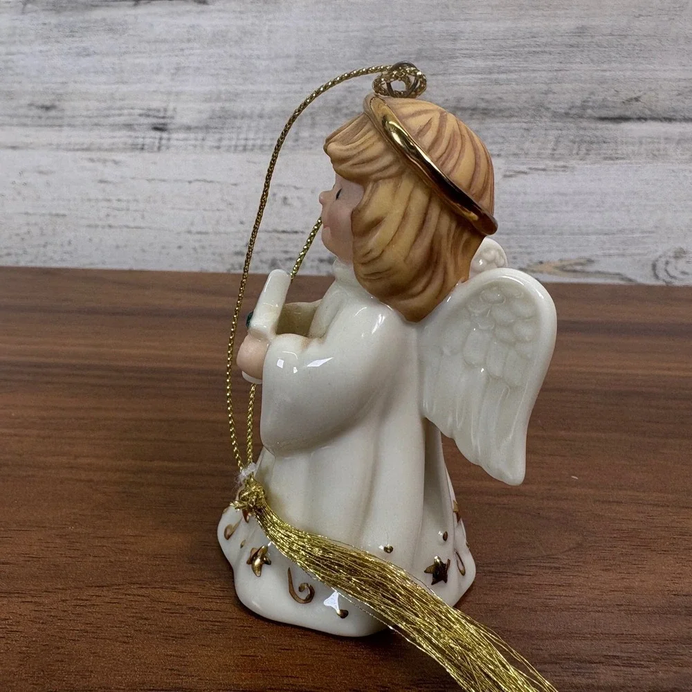 Lenox May birthstone Porcelain Angel Ornament features a hand-painted gold halo